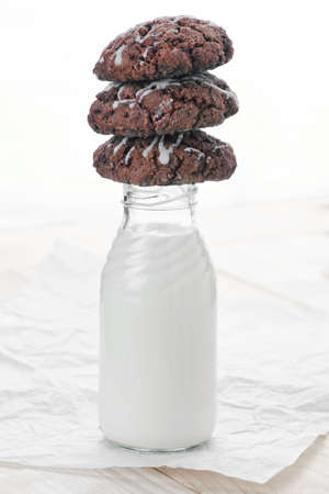 bottle of milk with chocolate cookiesの写真素材
