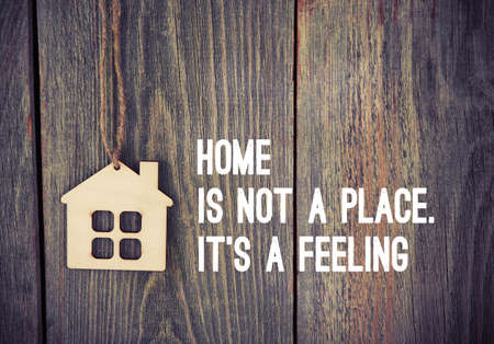 house as symbol on wooden background with quoteの写真素材