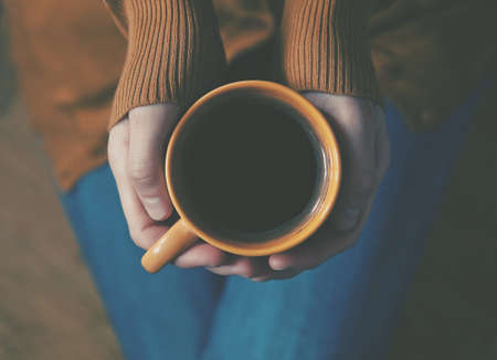 cup of coffee in handsの写真素材