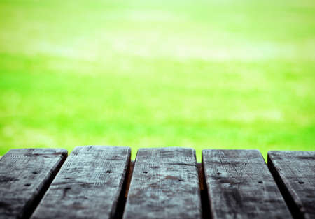 wooden boards of table on natural green backgroundの写真素材