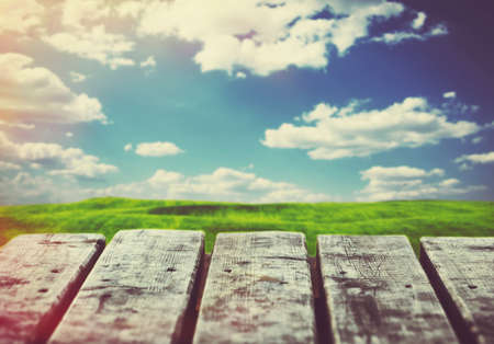 wooden boards of table on sky and field background