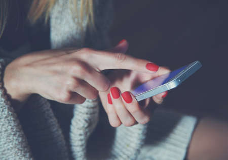 hands with smartphone touching screen and using app