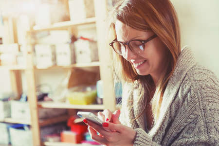 pretty woman with smartphone touching screen and using app pretty woman with smartphone touching screen and using app