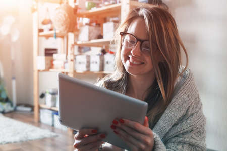 pretty woman with digital tablet at home