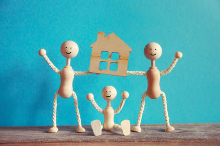 wooden little men with new house modelの写真素材