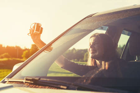 happy girl making selfie self portrait in car