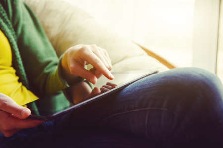 hands holding digital tablet pc and touching with finger