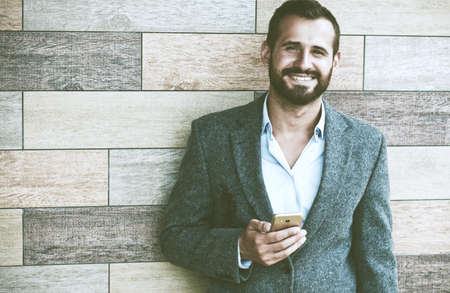 Handsome businessman using smart phoneの写真素材