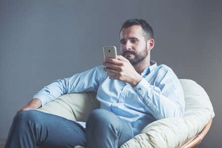 Handsome businessman using smart phoneの写真素材