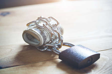 Locked chain with cash money. Safe shopping and money keeping conceptの写真素材