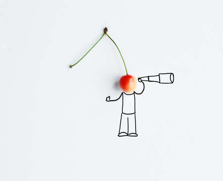 Cherry with hand drawing shape looking with spyglass. Loneliness and love searching concept