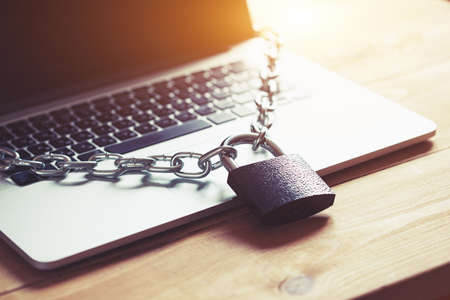 Locked chain on laptop as computer protection and cyber safety concept. Private data protection from...
