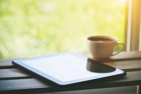 Cup of morning coffee with tablet computerの写真素材