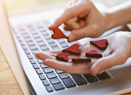 hand collecting hearts as like symbol in social media for posts and photos