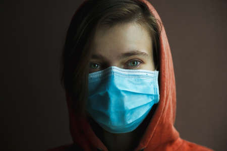 Portrait of woman wearing medical mask. Protection from catching disease. Pandemic of coronavirus concept.の写真素材