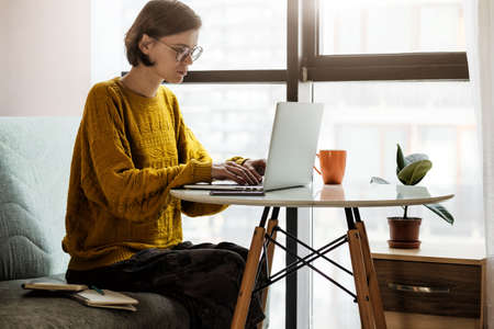 Woman working with laptop at home quarantine. Stay at home campaign.の写真素材