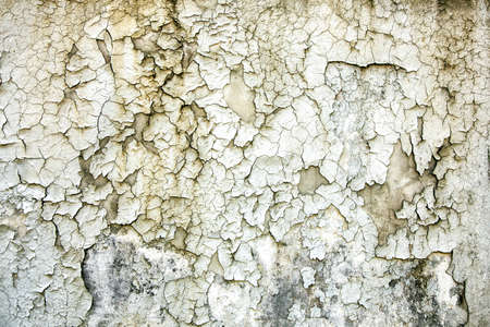 Texture of old paint. Aged cracked plaster on wall backgroundの写真素材