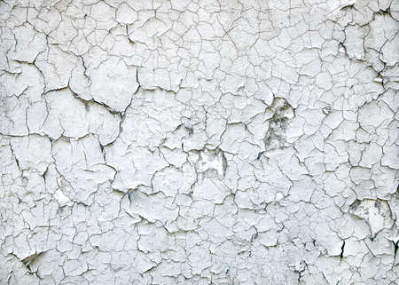 Texture of old paint. Aged cracked plaster on wall backgroundの写真素材