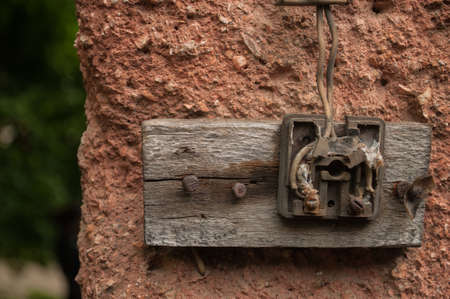 Old electric outlet in an old house interior on wall concreteの写真素材