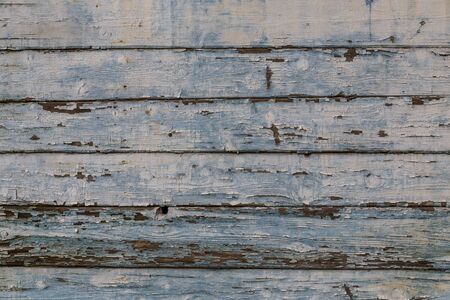 Horizontal wooden planks with peeling off white paint. Background, textureの写真素材