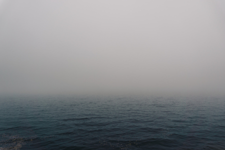 Fog over the water of the lake in autumn day. Abstract background imageの写真素材
