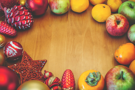 Christmas background with decorations and fruits on wooden table with copy space. Top view.の写真素材