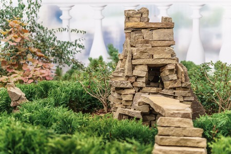Decorative small house for garden in the form of a stone cave with a ladderの写真素材