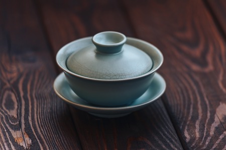 Gaiwan or tea cup for Chinese tea ceremony on wooden background. Copy space.の写真素材