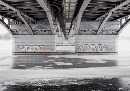 View at frozen river or lake under Chernavsky Bridge in Voronezh city. Winter time. Symmetryの写真素材