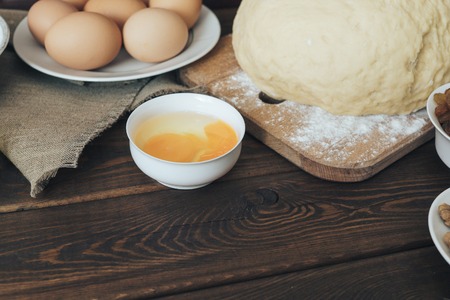 wooden rustic kitchen board with organic ingredients for cooking cake. preparation for baking cake. culinary conceptの写真素材