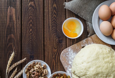 Baking ingredients for homemade pastry on dark rustic wooden background. culinary concept Copy spaceの写真素材