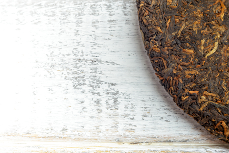 Close up image of old Shu puerh chinese fermented tea on rustic wooden background with copyspace. Top viewの写真素材
