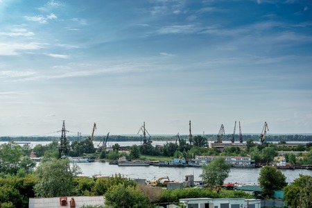 River Industrial Zone with cranes for loading ships. Blue sky with copy spaceの写真素材