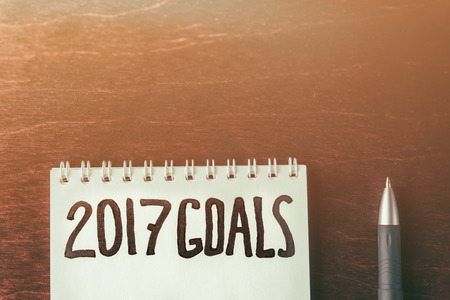 2017 goals on paper note book background and pen on wood table, business and strategy for motivation...