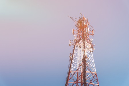 repeater tele communication tower with blue sky on background. Cell phone tower used to transmit telephony signal. Toned image with copy spaceの写真素材