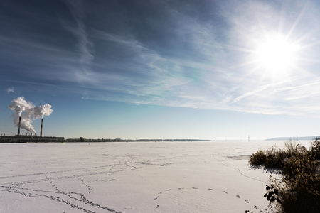 Industrial zone, petrochemical industry on sunset and Twilight sky, Power plant, Energy power station area on frozen winter lake. HDR image, copy spaceの写真素材