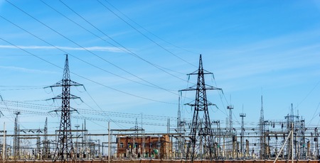 high voltage power lines at blue sky. electricity distribution station. high voltage electric transmission towers.の写真素材