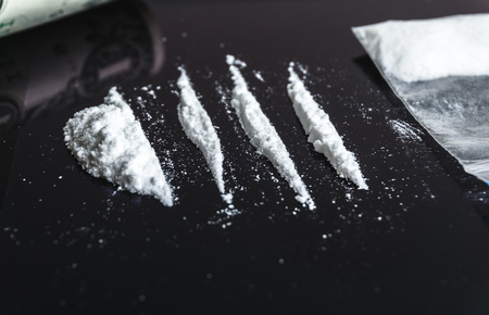Cocaine drug addiction. Lines of cocaine on black background closeupの写真素材