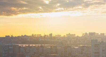 Sunset cityscape in yellow pastel tones, architecture, buildings at sunset lights