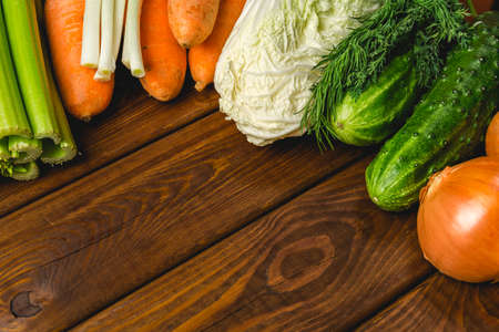 Group of organic vegetables on rustic wooden table with copy space for textの写真素材