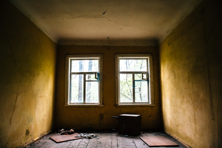 Room with two windows in abandoned ruined house, abandoned building inside interiorの写真素材
