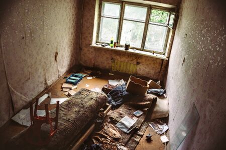 Room in an abandoned building, broken furniture, Asylum or shelter or Housing of homeless peopleの写真素材