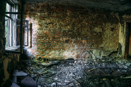 Interior of a burnt by fire apartment in an apartment building, burned furnitureの写真素材