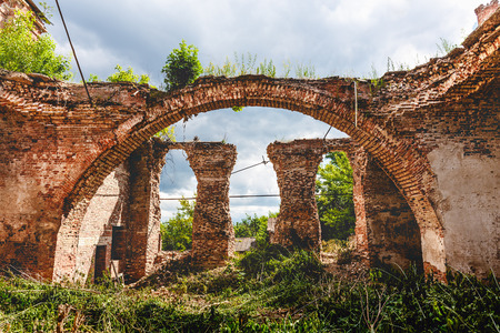 Ruins of an ancient destroyed abandoned Orthodox temple or church of red brick with big Arches in Yeletz, Lipeck region, Russiaの写真素材