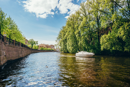 White boat on one of the canals and rivers of St. Petersburg, view from the waterの写真素材