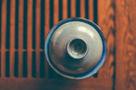 Chinese tea cup on wooden tea table, top  view, copy space, selective focusの写真素材