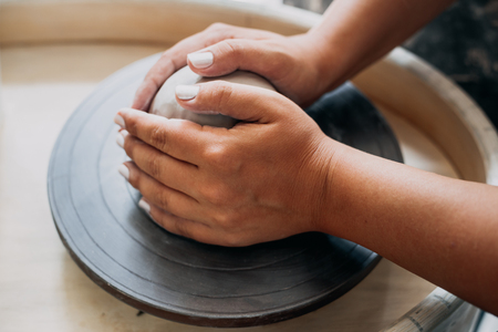 Pottery wheel, clay, woman's hands, potter is going to work in pottery, selective focusの写真素材