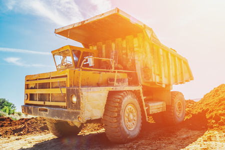 Quarry truck in sunlight, processes of extraction of clay and minerals in mineの写真素材