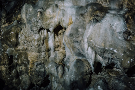 Wall with limestone formation in ancient underground caveの写真素材