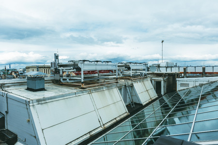 The roof of a modern building, glass ceilings and ventilation system, toned